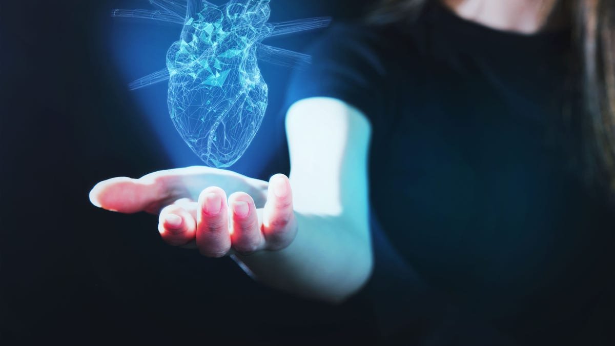 A person holding an AI heart in their hand