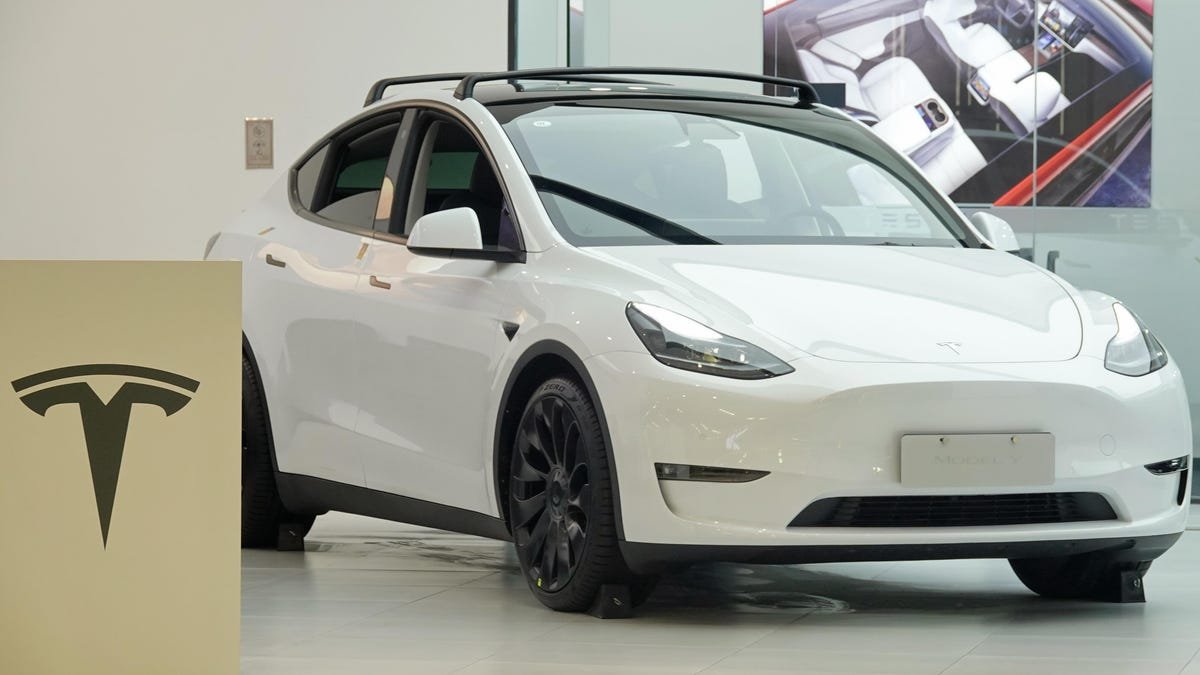 a tesla model y car in a showroom